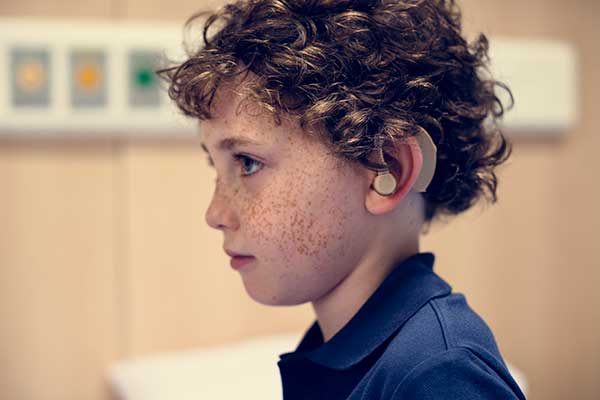 Boy with hearing aid